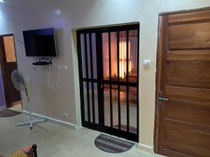 a room with a door and a television and a room with a door at Jamm in Saint-Louis