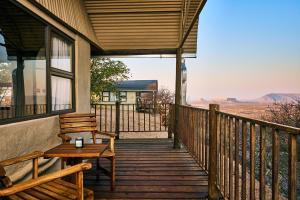 a porch with a bench and a view of the desert at Ugab Terrace Lodge in Fingerklippe 