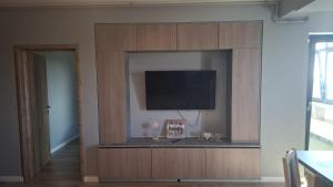 a large entertainment center with a flat screen tv at AndyRa in Agigea
