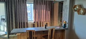 a kitchen with a counter with chairs and a window at AndyRa in Agigea