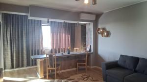 a living room with a desk with a mirror and a couch at AndyRa in Agigea +11 photos
