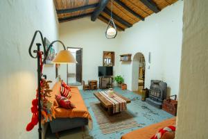 a living room with a couch and a table at La Rosada, Tilcara in Tilcara