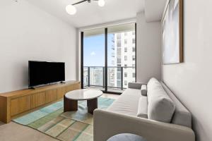 a living room with a couch and a flat screen tv at Downtown Luxury Condo withPool & Skyline Views in Miami
