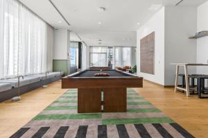a pool table in the middle of a room at Downtown Luxury Condo withPool & Skyline Views in Miami +21 photos