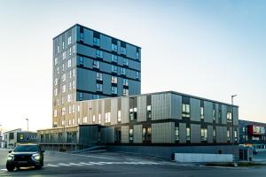 a car is parked in front of a building at Hotel Aurora Apartments in Nuuk
