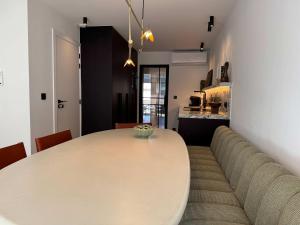 a dining room with a table and a couch at Casiola - Design apartment with sea views in Knokke-Heist +10 photos