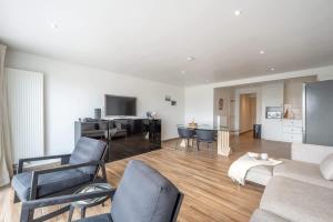 a living room with a couch and a table at 2-slaapkamer appartement met zicht op de Haven in Blankenberge