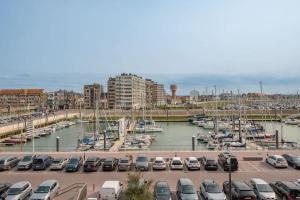 a parking lot with cars parked in a marina at 2-slaapkamer appartement met zicht op de Haven in Blankenberge +15 photos