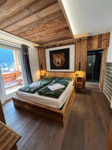 a bedroom with a bed in a room at Cuore Tana dell'Orso in Campitello di Fassa