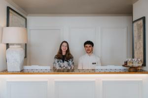 a man and a woman standing in front of a mirror at AlmaLusa Alfama in Lisbon