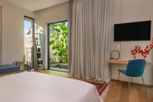 a bedroom with a bed and a large window at Nõs Luxury Rooms in Missolonghi