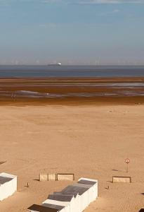 a sandy beach with the ocean in the background at Casiola - Beach Studio with Balcony & Sea View in Zeebrugge +9 photos