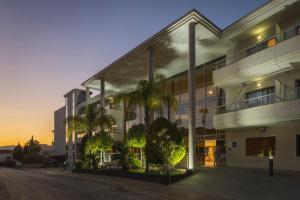 a large building with palm trees in front of it at Hotel Sun Palace Albir & Spa in Albir