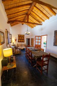 a dining room with a large wooden table and chairs at La Rosada, Tilcara in Tilcara