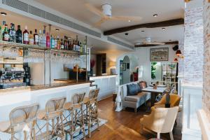 a bar in a restaurant with chairs and a table at AlmaLusa Alfama in Lisbon