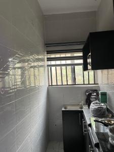 a small kitchen with a sink and a window at The Grace Villa in Abeokuta