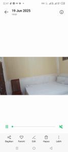 a screenshot of a picture of a bed in a room at Suryawijaya in Timuran