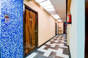 a hallway of an office with blue tiles on the walls at Super Collection O Circus Avenue Road Formerly Hotel Rockstar in Kolkata