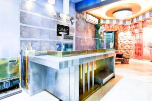 a restaurant with a counter in a room at Super Collection O Circus Avenue Road Formerly Hotel Rockstar in Kolkata