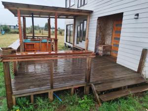 a porch of a house with a wooden deck at Cabaña Mymemprende in Río Bueno