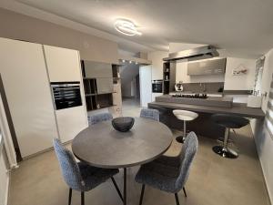 a kitchen with a table and chairs in a room at Apartment Jasmina in Venzone