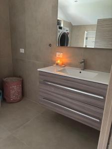 a bathroom with a sink and a mirror at Apartment Jasmina in Venzone +6 photos