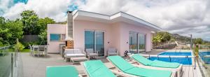 a villa with a swimming pool and blue chairs at Villa Azinhaga in Gaula