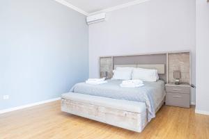 a white bedroom with a large bed with white pillows at Old Town T1 Apartment in Funchal