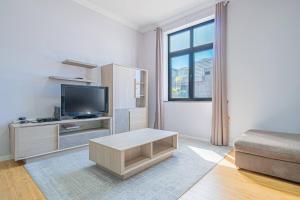 a living room with a tv and a couch at Old Town T1 Apartment in Funchal