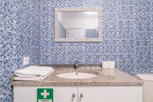 a bathroom with a sink and a mirror at Old Town T1 Apartment in Funchal +20 photos