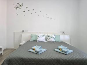 a bedroom with a bed with towels on it at "Felicita" San Francesco lake view Relax Apartment in Lecco