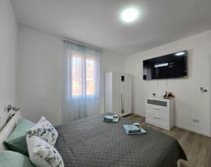 a bedroom with a bed with a television on the wall at "Felicita" San Francesco lake view Relax Apartment in Lecco