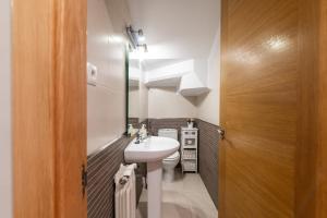 a bathroom with a white sink and a toilet at Casa Llanes (Poo) cerca de la playa - Traudel in Llanes +29 photos