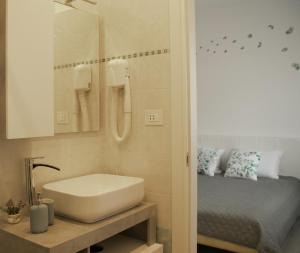a bathroom with a white sink and a bed at "Felicita" San Francesco lake view Relax Apartment in Lecco +36 photos