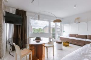 a living room with a table and a couch at Sea views - beachfront - in the heart of Knokke-Heist in Knokke-Heist