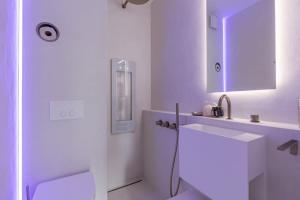 a white bathroom with a sink and a mirror at Sea views - beachfront - in the heart of Knokke-Heist in Knokke-Heist +24 photos