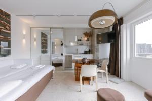 a bedroom with a table and a bed and a dining room at Sea views - beachfront - in the heart of Knokke-Heist in Knokke-Heist