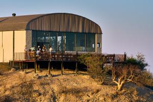 a group of people standing outside of a building at Ugab Terrace Lodge in Fingerklippe  +19 photos