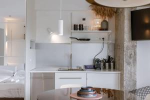 a white kitchen with a sink in a room at Sea views - beachfront - in the heart of Knokke-Heist in Knokke-Heist