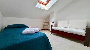 a bedroom with a bed and a couch at apartament skyline park residense in Lignano Sabbiadoro +24 photos