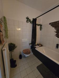 a bathroom with a tub and a toilet and a bath tub at Magische Welt in Bautzen +16 photos