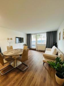 a living room with a table and chairs and a couch at Ferienwohnung Nelli in Sankt Englmar