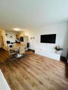 a living room with a table and a flat screen tv at Ferienwohnung Nelli in Sankt Englmar