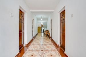 a hallway with doors and a tile floor at Super Collection O Calangute in Goa