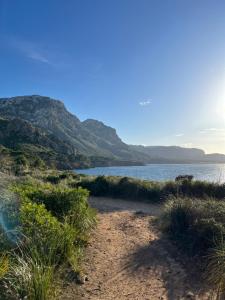 a beach with a view of the water and mountains at Vila Mimosa in Colonia de Sant Pere