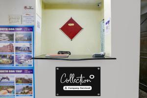 a counter with a sign on a wall at Super Collection O Calangute in Goa