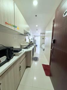 a kitchen with a counter top and a room at Sparkle2600 at Megatower 1 in Baguio
