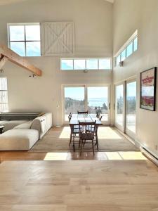 a living room with a table and a couch at The Beach Barn & Cedar Sauna in Kingsburg +28 photos