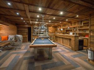 a pool table in a room with wooden walls at Chalet K2 in Isola