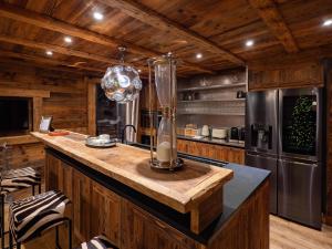 a kitchen with wooden walls and a large island in a kitchen at Chalet K2 in Isola